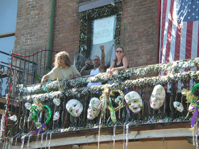 Revelers throwing Mardi Gras beads