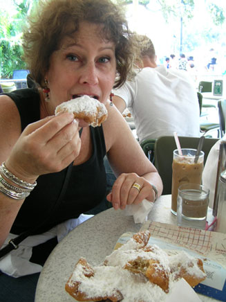 Carol enjoying beignets at Cafe du Monde
