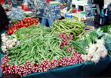 Radishes, greenbeans and onions at a market